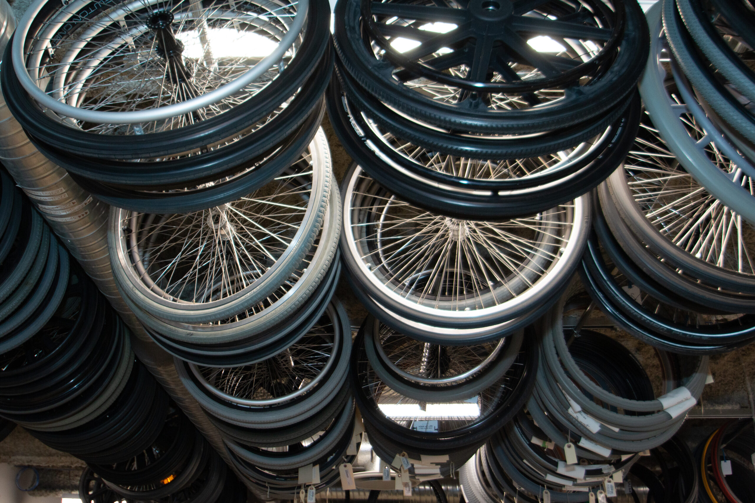 Wheelchair wheels hang from the ceiling like art.
