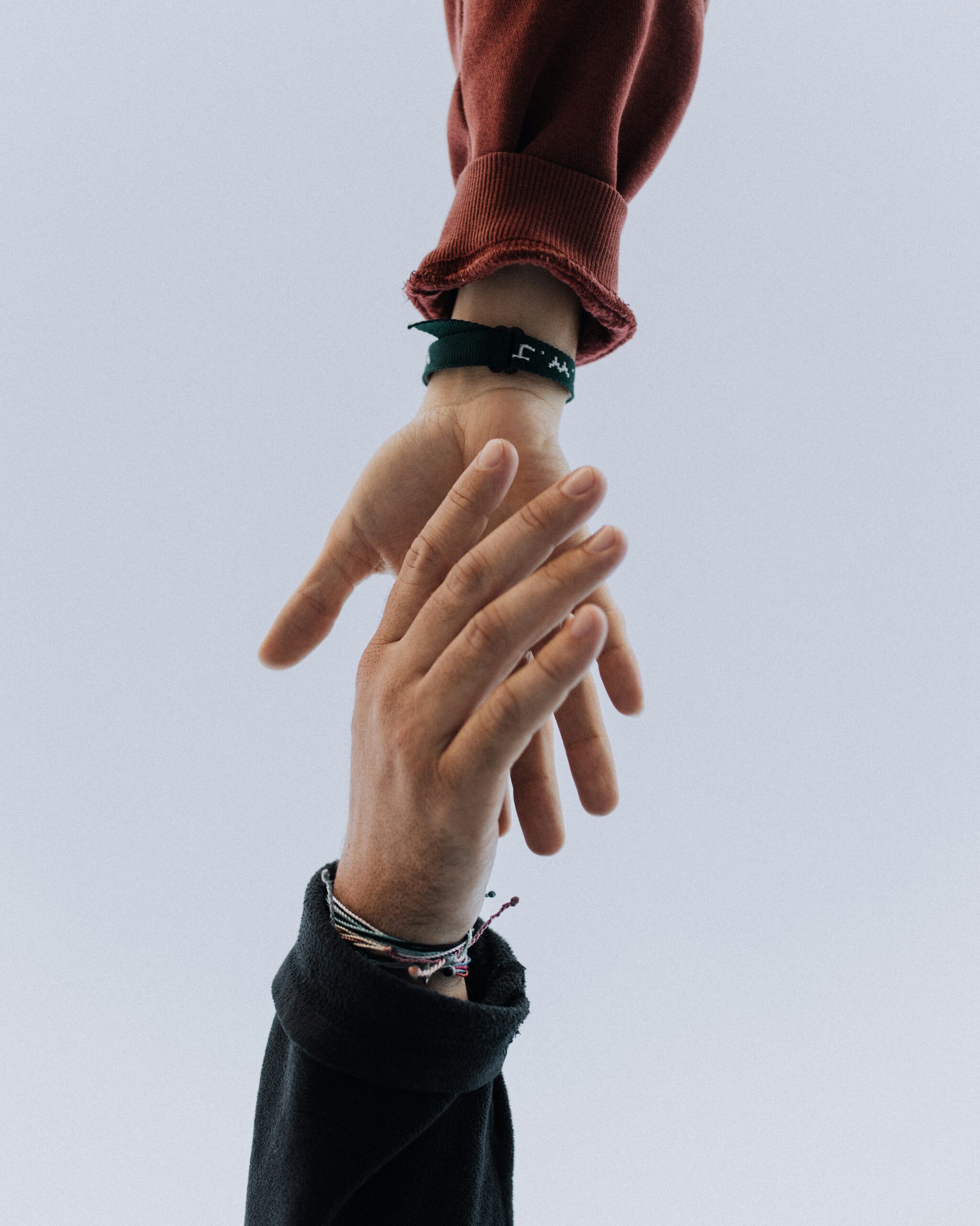 Two hands reaching for each other.
