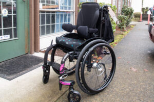 Pediatric Wheelchair with purple accents and star cushion